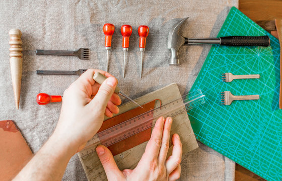 Man Working With Leather Using Crafting DIY Tools.