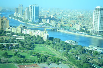  Nile river in Cairo Egypt during the day with boats running and high building surrounding river banks