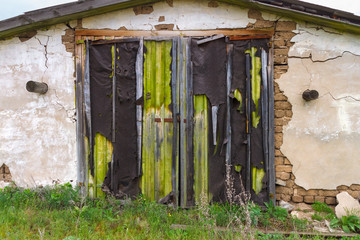 The locked entrance in the old abandoned brick barn