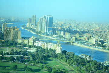  Nile river in Cairo Egypt during the day with boats running and high building surrounding river banks