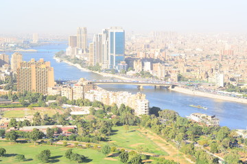Nile river in Cairo Egypt during the day with boats running and high building surrounding river banks