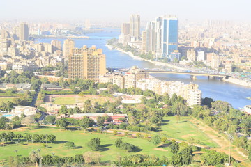 Nile river in Cairo Egypt during the day with boats running and high building surrounding river banks