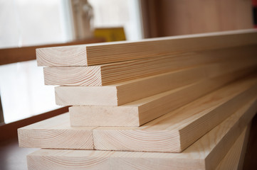 Wood boards. Timber in stock. Many new boards in stock. Planed boards are stacked.
