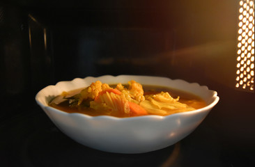Look inside the microwave food white bowl, In a warm atmosphere and empty top space for text. (Spicy food). Non color ceramic applicable to available with microwave.