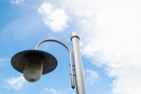 Fototapeta street lamp post new style design and blue sky and white clouds . space for text background