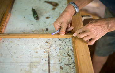 The hands of those who are working to repair the carpentry work with neatness.