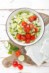 Healthy vegetable salad of chinese cabbage, corn, cucumbers and tomatoes. Delicious vegetarian dietary lunch. Vegan food. Top view. Flat lay