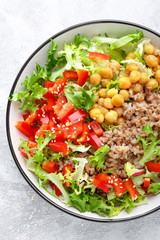 Healthy and delicious bowl with buckwheat and salad of chickpea, fresh pepper and lettuce leaves. Dietary balanced plant-based food. Vegan and vegetarian dish. Top view. Flat lay