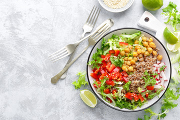 Healthy and delicious bowl with buckwheat and salad of chickpea, fresh pepper and lettuce leaves. Dietary balanced plant-based food. Vegan and vegetarian dish. Top view. Flat lay