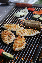 
Sausages and chicken breasts barbecue, simple outdoor party food preparation