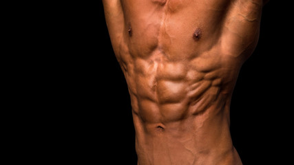 Muscular male torso with petfect abs on black background.