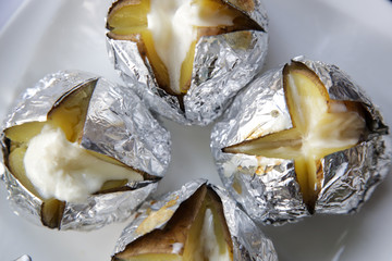 Jacket potato in aluminum foil, simple barbecue food