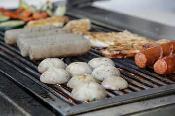 
Sausages, chicken breasts and mushrooms grill, simple outdoor party food preparation