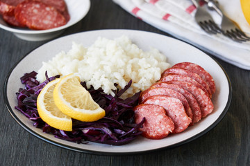 Boiled rice with sausage and red cabbage