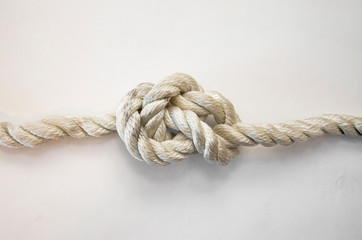 nautical knots tied by the rope of a rope on white background
