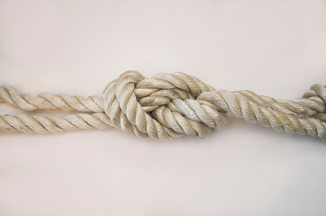 nautical knots tied by the rope of a rope on white background