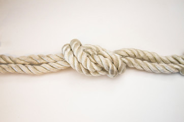 nautical knots tied by the rope of a rope on white background