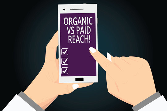 Writing note showing Organic Vs Paid Reach. Business photo showcasing Increasing followers naturally or by paying for it Hu analysis Hands Holding Pointing Smartphone Blank Color Screen