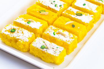 Indian Popular Sweet Food Khopara Pak or Coconut Burfi made up of Coconut, Milk And Sugar Isolated on White Background