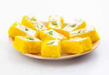 Indian Popular Sweet Food Khopara Pak or Coconut Burfi made up of Coconut, Milk And Sugar Isolated on White Background