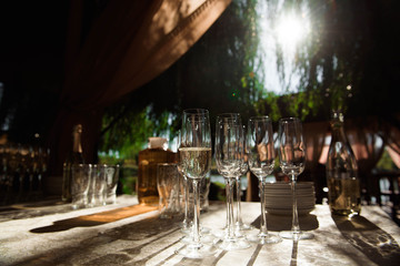 Waiter pours champagne in glasses, luxury event.