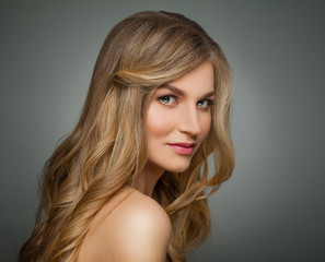 Naklejka premium Cute blonde woman with long healthy hair and clear skin portrait
