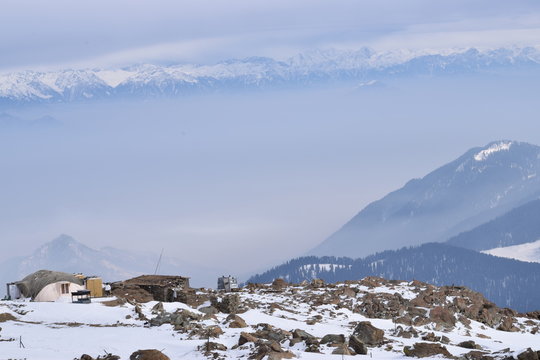 View from Mount Apharwat at a height of 4390 metres in Gulmarg, Kashmir, India. It lies in Pir Panjal mountain range in Indian Himalayas. It remains covered with heavy snow throughout the year.