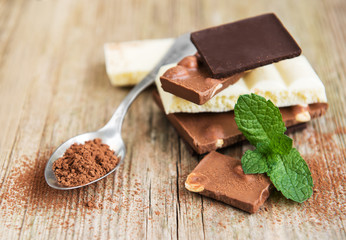 Chocolate and cocoa powder  on a old wooden table