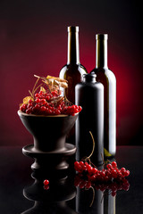 Still life with berries of viburnum red and bottles