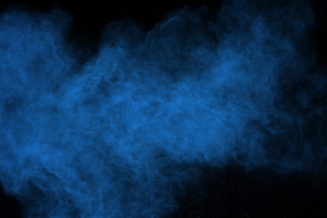 abstract blue powder splatted background. Colorful powder explosion on black background. Colored cloud. Colorful dust explode. Paint Holi.