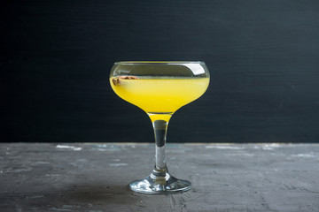 Citrus beverage with spices in margarita glass. Selective focus. Shallow depth of field. 