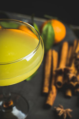 Citrus beverage with spices in margarita glass. Selective focus. Shallow depth of field. 