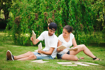 Young man and woman playing giant dominoes in the Park on the grass.