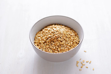 White bowl of dry oatmeal