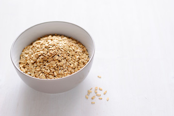 White bowl of dry oatmeal