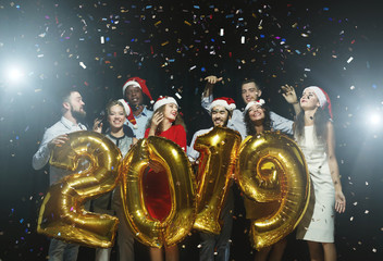 Happy friends having fun at new year celebration