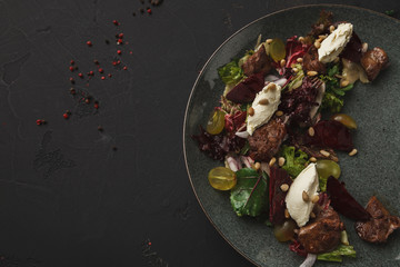 Warm salad with beetroot and cheese served at restaurant