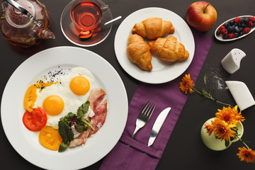 Restaurant breakfast with bacon and fried eggs