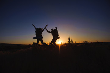 Silhouette of young couple against colorful sunset