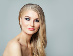 Perfect blonde woman with long healthy hair and clear skin. Facial treatment, haircare and cosmetology concept