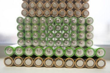 Electric batteries and accumulators size AAA AA lot of green in the package in the store. Shallow depth of field