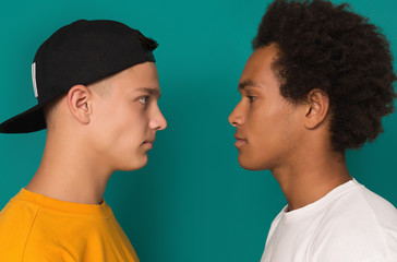 Two teens looking at each other after conflict - obrazy, fototapety, plakaty