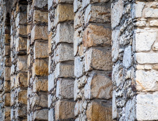 Abstract photo of the back very thick stone wall of a hotel in the Goslar old town.