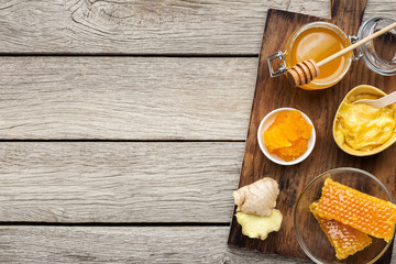 Honey in jar with fresh ginger on vintage wooden background