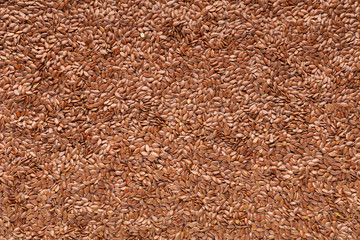 Background with heap of flax seeds, closeup
