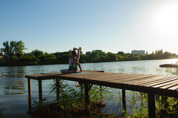 Young girl doing yoga fitness exercise outdoor in beautiful landscape. Morning sunrise. Meditation and Relax.