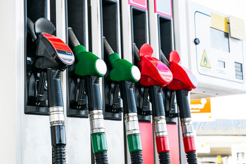 Gasoline and diesel distributor at the gas station. Gas pump nozzles. Petrol filling gun close-up...