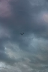 Fototapeta na wymiar Airliner plows the cloudy sky