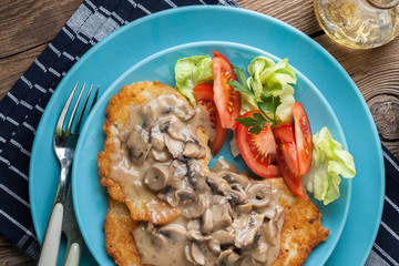 Crispy fried homemade potato pancakes with mushroom sauce.