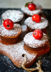 Fresh Homemade Quince Muffins sprinkled with powdered sugar and small red apples as decor